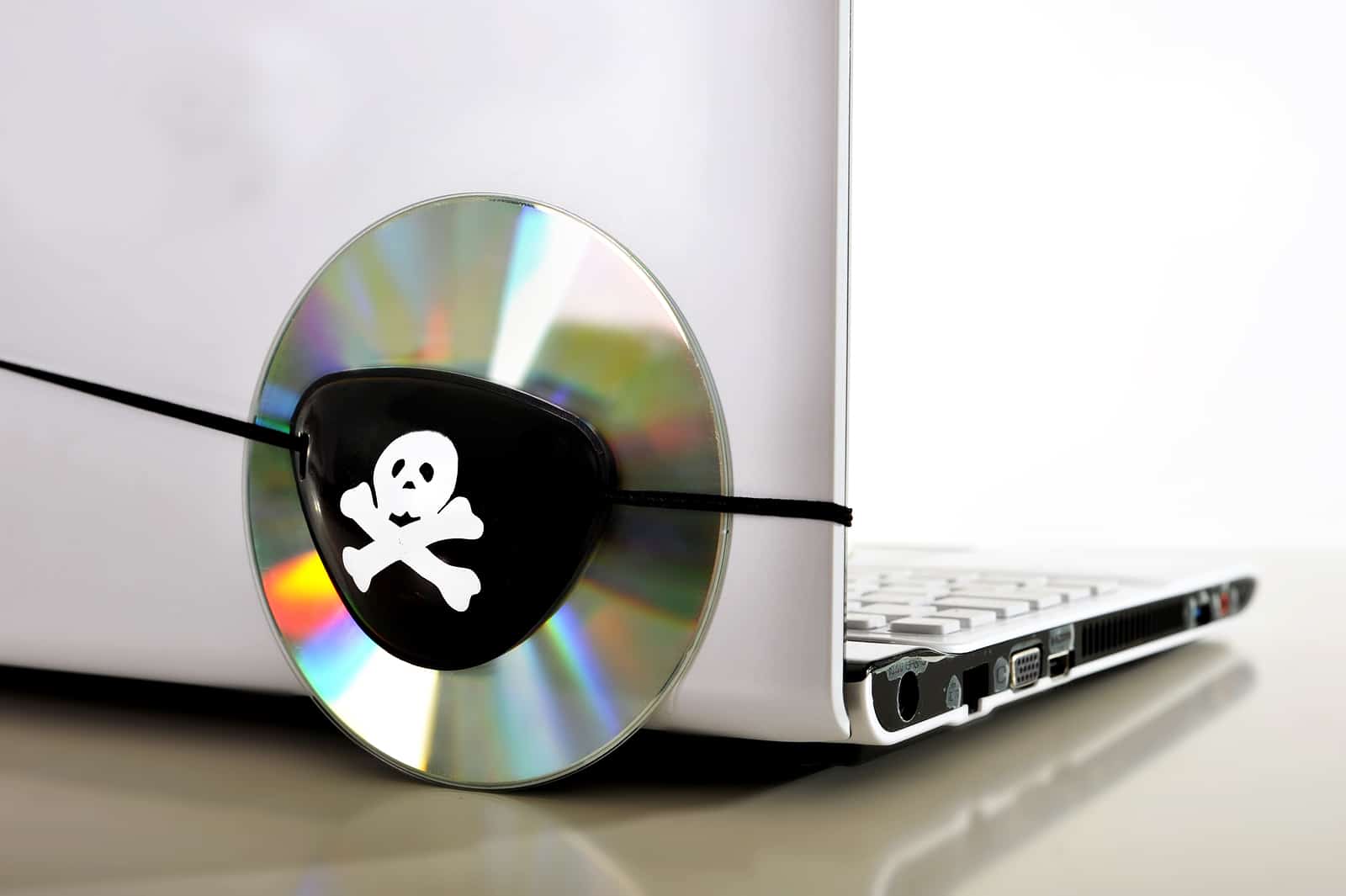 Young Man In Pirate Costume And Computer