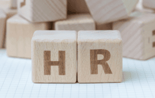 light brown blocks stacked beside each other spelling "HR"